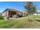 Exterior view of a home featuring a screened-in patio, perfect for outdoor enjoyment and entertaining at 17398 Blazing Star Cir, Clermont, FL 34714