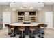 Modern community bar area with sleek counter, chairs, tile backsplash, and stylish pendant lighting at 17398 Blazing Star Cir, Clermont, FL 34714