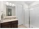 Bright bathroom with granite vanity and walk-in shower with glass door at 17398 Blazing Star Cir, Clermont, FL 34714