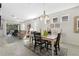 Open-concept dining room with a chandelier, and seamless flow into the living room and outdoor patio at 17398 Blazing Star Cir, Clermont, FL 34714