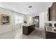 Modern kitchen featuring stainless steel appliances, granite countertops, and a center island with bar seating at 17398 Blazing Star Cir, Clermont, FL 34714