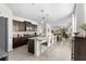 Open kitchen featuring stainless appliances, granite counters, breakfast bar, and seamless access to dining and living spaces at 17398 Blazing Star Cir, Clermont, FL 34714