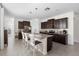 Well-equipped kitchen with stainless steel appliances, granite countertops, and a center island with seating at 17398 Blazing Star Cir, Clermont, FL 34714