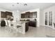 Stylish kitchen with dark wood cabinets, granite countertops, stainless steel appliances, and a spacious center island at 17398 Blazing Star Cir, Clermont, FL 34714