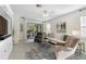 Inviting living room with neutral tones, ceiling fan, and view to patio at 17398 Blazing Star Cir, Clermont, FL 34714