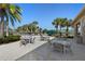Beautiful outdoor seating area with tables, chairs, and lush landscaping at 17398 Blazing Star Cir, Clermont, FL 34714