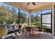 Screened-in patio with cozy seating, offering serene views of the backyard at 17398 Blazing Star Cir, Clermont, FL 34714