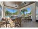 Charming covered patio with wood ceiling and comfortable seating overlooking the pool at 17398 Blazing Star Cir, Clermont, FL 34714