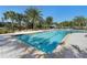 Inviting community swimming pool surrounded by lush landscaping and lounge chairs at 17398 Blazing Star Cir, Clermont, FL 34714