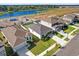 An aerial view of the house, its manicured lawn, and proximity to a serene lake at 1773 Groveline Rd, St Cloud, FL 34771