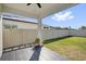 Backyard features well-maintained lawn, gray flooring, and a white fence at 1773 Groveline Rd, St Cloud, FL 34771