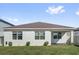 Exterior view of backyard, highlighting the well-maintained lawn and covered patio at 1773 Groveline Rd, St Cloud, FL 34771