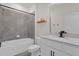 Modern bathroom featuring tiled shower and tub with modern vanity and fixtures at 1773 Groveline Rd, St Cloud, FL 34771