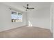 Bright bedroom featuring neutral carpet, a modern ceiling fan and a large window at 1773 Groveline Rd, St Cloud, FL 34771