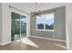 Bright dining area with sliding door access, window, and stylish light fixture at 1773 Groveline Rd, St Cloud, FL 34771