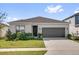 Charming single-story home featuring a well-manicured lawn and an attached two-car garage at 1773 Groveline Rd, St Cloud, FL 34771