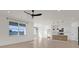 Spacious living room with tile floors, large windows, and open layout to kitchen at 1773 Groveline Rd, St Cloud, FL 34771