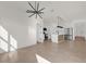 Open-concept living space features modern lighting, tile flooring, and kitchen with stainless appliances at 1773 Groveline Rd, St Cloud, FL 34771