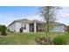 Landscaped backyard featuring a screened lanai and a neatly maintained lawn at 2087 Flora Pass Pl, Kissimmee, FL 34747