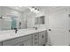 Elegant bathroom features double sinks, quartz counters and glass enclosed shower at 2087 Flora Pass Pl, Kissimmee, FL 34747