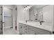 Modern bathroom features double sinks, sleek countertops, and a glass-enclosed shower at 2087 Flora Pass Pl, Kissimmee, FL 34747