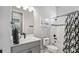Bathroom features a modern vanity, toilet, tub-shower combo with sleek black hardware, and patterned shower curtain at 2087 Flora Pass Pl, Kissimmee, FL 34747