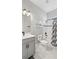 Bright bathroom showcases a vanity, toilet, and shower-tub with stylish tile and modern fixtures under soft lighting at 2087 Flora Pass Pl, Kissimmee, FL 34747