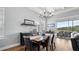 The dining area features a modern light fixture, comfortable seating, and access to an outdoor patio at 2087 Flora Pass Pl, Kissimmee, FL 34747