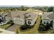 This exterior aerial showcases a charming home with a brick driveway, lush landscaping, and a two-car garage at 2087 Flora Pass Pl, Kissimmee, FL 34747