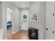 Bright foyer with hardwood floors, decorative table, and view into the bedroom at 2087 Flora Pass Pl, Kissimmee, FL 34747