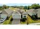 Exterior aerial showcases a well-manicured front yard, a brick driveway, and an attached two-car garage at 2087 Flora Pass Pl, Kissimmee, FL 34747