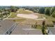 Aerial of home backing onto well-kept golf course with sand traps and a path at 2087 Flora Pass Pl, Kissimmee, FL 34747