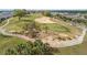 Scenic aerial of a manicured golf course with lush green fairways, sand traps, and meticulously maintained landscaping at 2087 Flora Pass Pl, Kissimmee, FL 34747