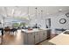 Open-concept kitchen featuring a large island, modern lighting, and views into the living area at 2087 Flora Pass Pl, Kissimmee, FL 34747