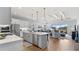Open-concept kitchen featuring an island, stainless steel appliances, and seamless flow to the living area at 2087 Flora Pass Pl, Kissimmee, FL 34747