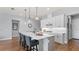 White gourmet kitchen with sleek appliances, subway tile backsplash, and a large center island at 2087 Flora Pass Pl, Kissimmee, FL 34747