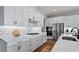 Modern kitchen with white cabinets, stainless steel appliances, quartz countertops, and a gas range at 2087 Flora Pass Pl, Kissimmee, FL 34747
