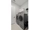 Functional laundry room featuring front-load washer and dryer, storage shelves, and good lighting at 2087 Flora Pass Pl, Kissimmee, FL 34747