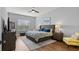 Serene main bedroom features wood floors, a large window, and neutral decor at 2087 Flora Pass Pl, Kissimmee, FL 34747