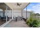 Screened patio with outdoor dining set, offering a relaxing outdoor space overlooking the backyard at 2087 Flora Pass Pl, Kissimmee, FL 34747