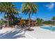 Relaxing outdoor seating area poolside featuring lounge seating beneath a wooden pergola and lush landscaping at 2087 Flora Pass Pl, Kissimmee, FL 34747