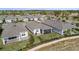 Aerial view of a well-maintained home featuring a screened lanai and beautifully landscaped backyard at 2087 Flora Pass Pl, Kissimmee, FL 34747