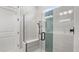 Modern shower features glass enclosure, integrated bench seating, and sleek hardware at 2087 Flora Pass Pl, Kissimmee, FL 34747