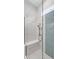 Modern shower with glass enclosure, integrated bench, and stylish tile work at 2087 Flora Pass Pl, Kissimmee, FL 34747