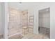 Modern bathroom featuring a tiled walk-in shower with glass door, decorative ladder, and a neutral color palette at 2099 Derwent Dr, Davenport, FL 33896