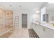 Bright bathroom with a glass-enclosed shower, double vanity, decorative ladder, and modern fixtures at 2099 Derwent Dr, Davenport, FL 33896