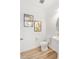 Modern powder room features a stylish pedestal sink, elegant light fixtures, and beautiful decorative wall art at 2099 Derwent Dr, Davenport, FL 33896