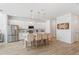 Modern kitchen featuring white cabinets, stainless steel appliances, and an island with bar stools at 2099 Derwent Dr, Davenport, FL 33896