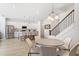 Open-concept kitchen with stainless steel appliances, pendant lighting, a breakfast bar, and an adjacent dining area at 2099 Derwent Dr, Davenport, FL 33896