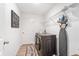 Functional laundry room is equipped with washer, dryer, ironing board, and storage shelves at 2099 Derwent Dr, Davenport, FL 33896